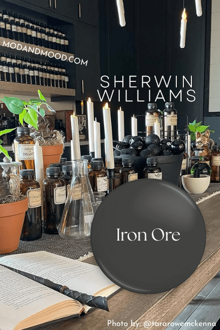 Swatch of Sherwin Williams Iron Ore over a photo of the color on a wall in a dining room.