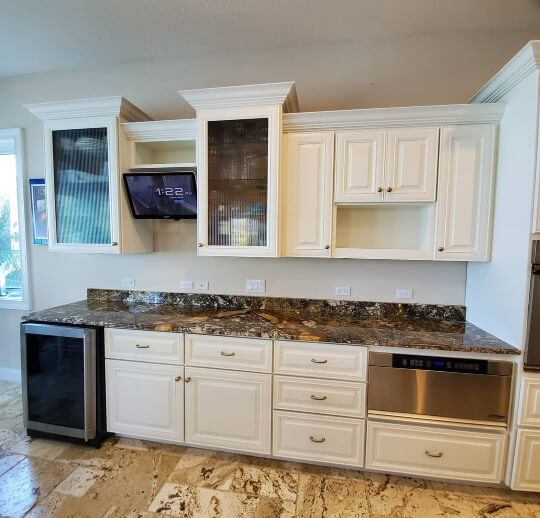 Alabaster cabinets with brown laminate countertops in a neutral kitchen