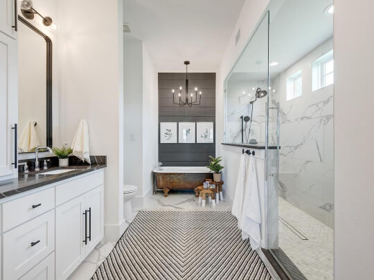 Pure White walls and trim in a gorgeous oversized bathroom with Cyberspace shiplap wall and beautiful marble walk in shower.