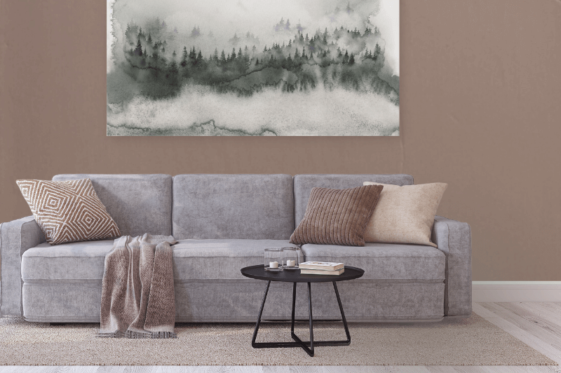 Sherwin Williams Redend Point on a wall behind a gray sofa with a forest watercolor painting on the wall