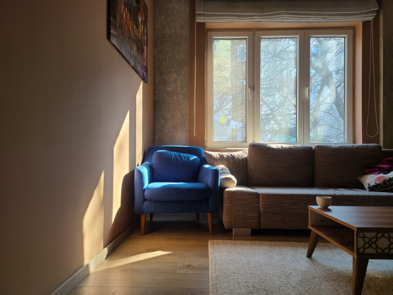 Redend Point on the wall in a living room with a blue armchair and sunbeams on the wall
