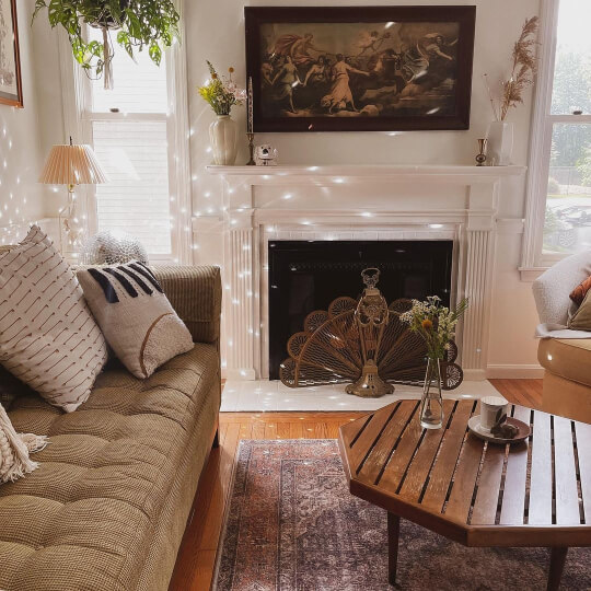 Alabaster in Living room with Alabaster Fireplace and walls and a vintage vibe with olive couch