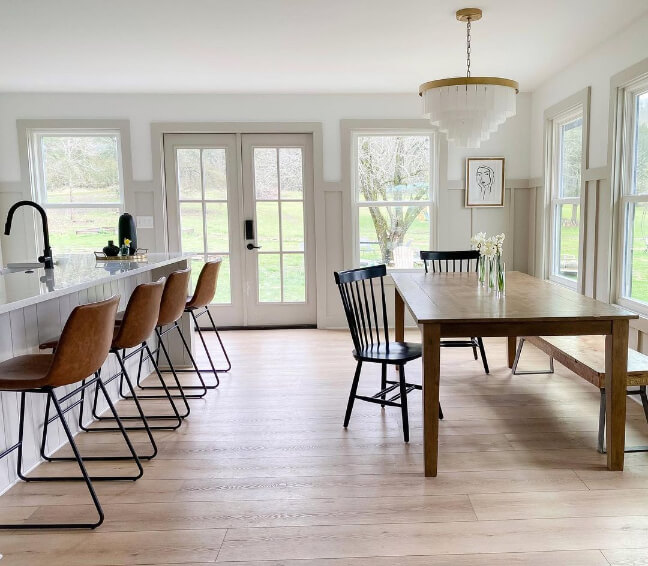 Sherwin Williams Agreeable Gray on trim and doors in an open plan living room dining room