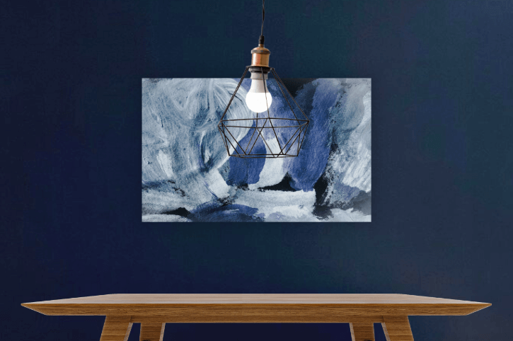 Deep Royal on a dining room wall with a canvas abstract blue painting and a wood table under a pendant lamp.