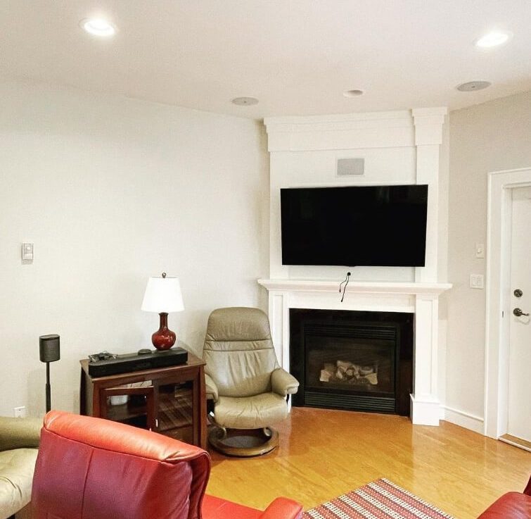 A White Dove floor to ceiling fireplace in a living room with Dove Wing Walls