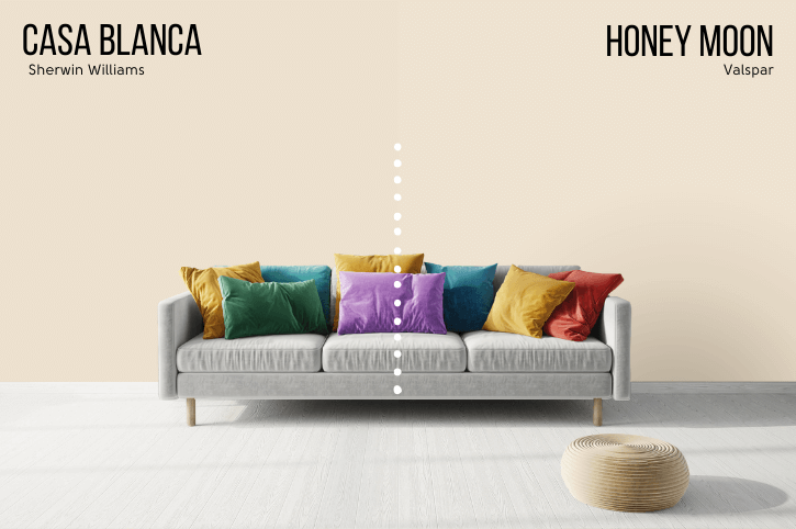 Valspar Casa Blanca Dupe Honey Moon on half of a wall with Casa Blanca on the other half behind a gray sofa with jewel toned cushions