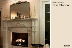 Swatch of Sherwin Williams Casa Blanca beside a living room wall painted in Casa Blanca with a white fireplace