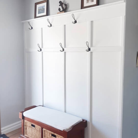 Behr Silver Bullet on a wall behind a white coat rack