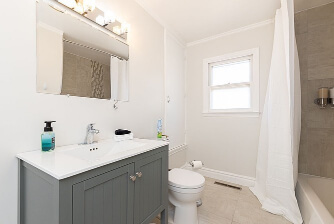 Irish Mist looks both creamy and gray in a small main floor bathroom