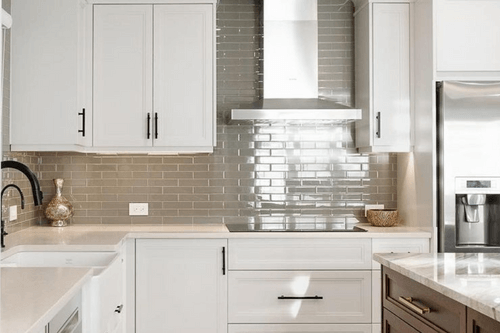 Behr Silver Drop on cabinets in a bright kitchen with gray tile backsplash