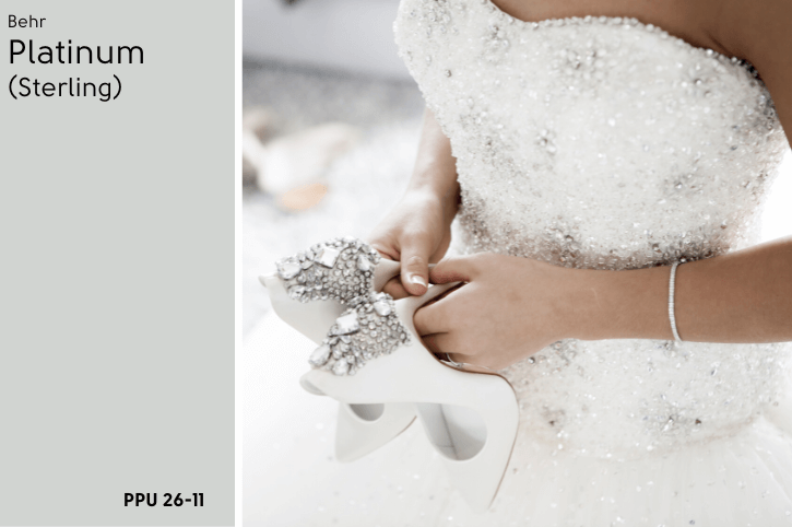 Behr Platinum swatched beside a photo of a bride holding white high heeled shoes with platinum beading and stones decorating the heels