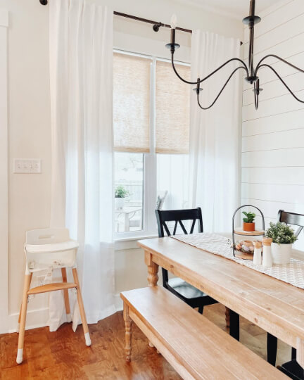 Dove Wing walls with boho natural wood table and simple black chandelier