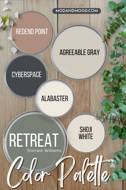 Retreat color palette features Sherwin Williams Retreat with Shoji White, Alabaster, Cyberspace, Agreeable Gray, and Redend Point all on paint lids scattered over a wooden worktop with Eucalyptus leaves running down the side.