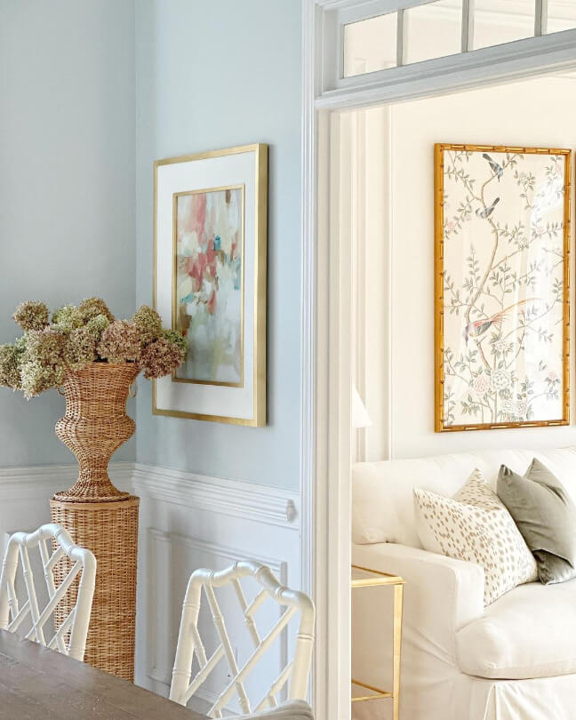 Light French Gray in a corner of a dining room with a framed painting on the wall and the white living room in view through a doorway