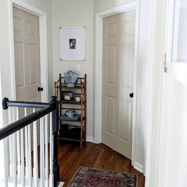 Sherwin Williams Shiitake on interior doors in an upstairs landing with Benjamin Moore classic gray walls and white trim