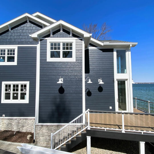 Benjamin Moore Soot siding on a two storey lake house style exterior with Simply White trim