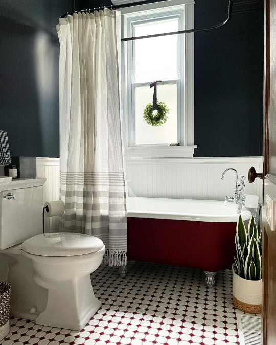 Benjamin Moore Soot on the top half of a wall with white wainscoting on the lower half and a clawfoot tub