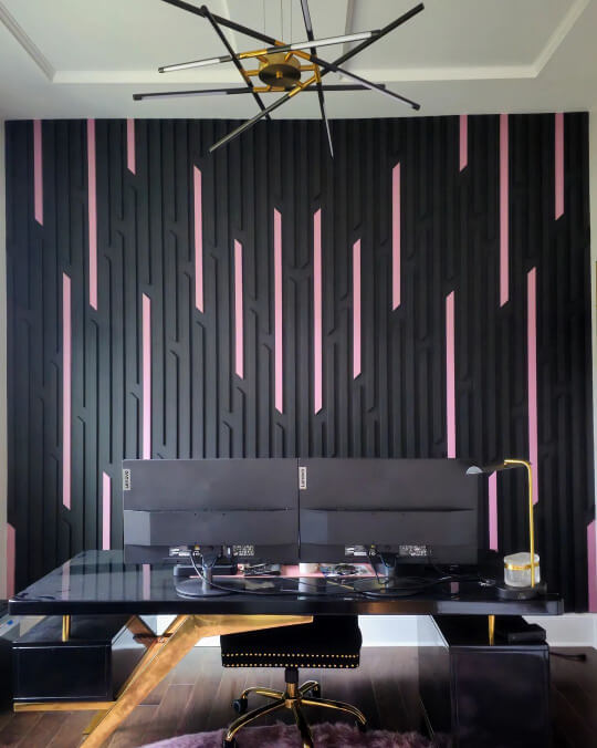 Tricorn black and Rose (pink) wood slat wall behind a double monitor desk in a large office living room