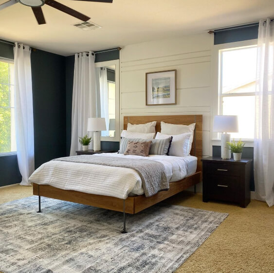 Grays Harbor on an accent wall in a large bedroom with creamy white walls and big windows and white linens on the bed