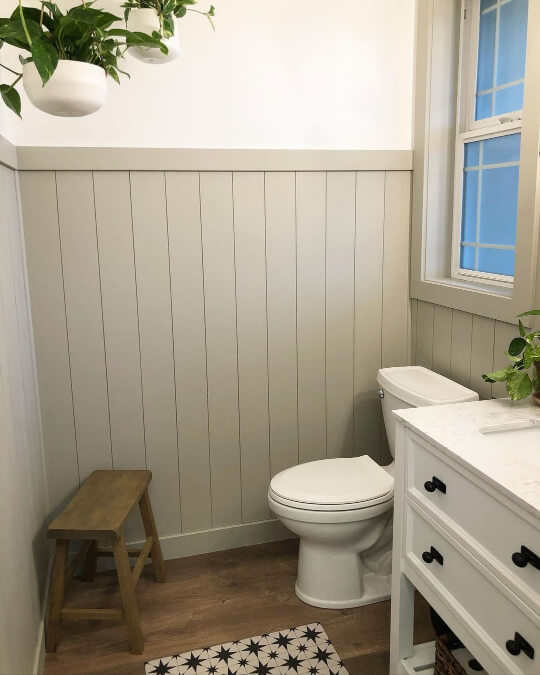Sherwin Williams Jogging Path on vertical shiplap on the lower half of a bathroom wall with white upper walls.