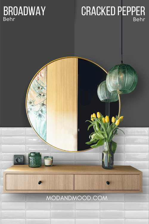 Behr Cracked Pepper on half of a wall and similar color Broadway on the other half behind a round gold mirror.