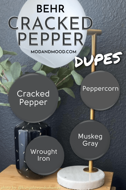 Cracked Pepper with dupes Muskeg Gray, Peppercorn, and Wrought Iron over a background of Cracked Pepper on a wall with a side table in front of it.