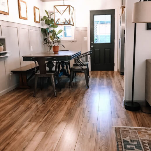 Behr Cracked Pepper on a door where it looks black in a dining room with beige board and batten on the walls.