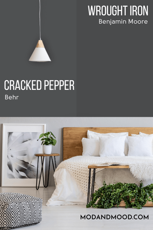 Behr Cracked Pepper on one half of a wall with dupe Wrought Iron on the other half behind a white sofa and neutral living room decor