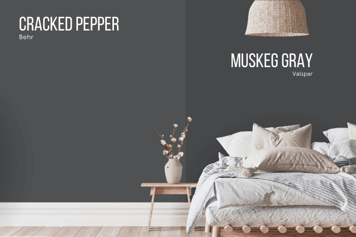 Behr Cracked Pepper on one half of a wall with Valspar dupe Muskeg Gray on the other half behind a bed with white linens