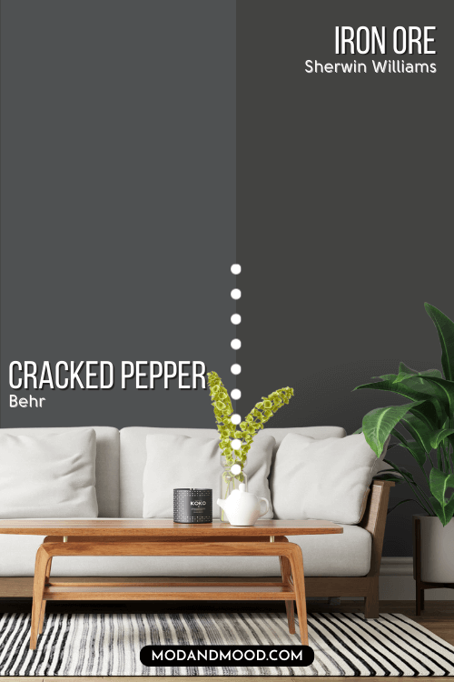 Behr Cracked Pepper on one half of a wall with Iron Ore on the other half behind a white sofa.