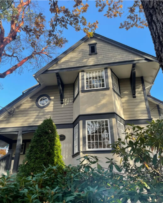 A two storey exterior in a custom beige color with Benjamin Moore Wrought Iron trim.