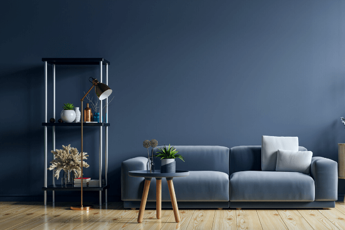 Benjamin Moore Blue Nova color on the walls in a living room with a blue velvet sofa