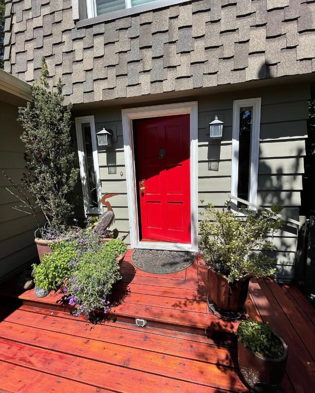 Sherwin Williams Svelte Sage lookalike on exterior siding with a bright red door and red stained deck