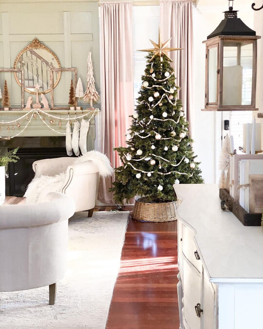 Sherwin Williams Svelte Sage on a fireplace wall in a living room with a Christmas tree and white decor