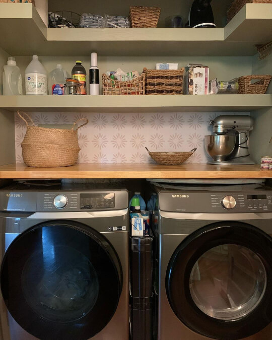 Svelte Sage on walls and shelves above a gary washer and dryer set in a small laundry room