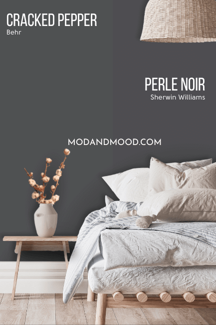 Sherwin williams Perle Noir on half of a wall with similar color Behr Cracked Pepper on the other half, behind a bed with plushy white and gray linens.