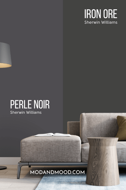 Sherwin williams Perle Noir on half of a wall with similar color SW Iron Ore on the other half, behind a light gray sofa with blue and neutral cushions.