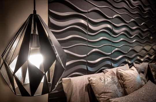 3D Paneled headboard painted in sherwin williams perle noir with a pendant lamp hanging in the foreground.
