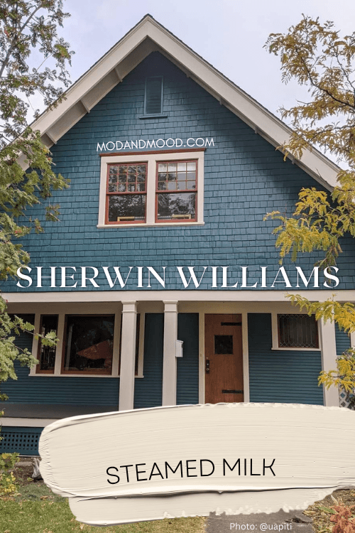 Sherwin Williams Steamed Milk swatched over a photo of the color on trim on a teal two storey house exterior.