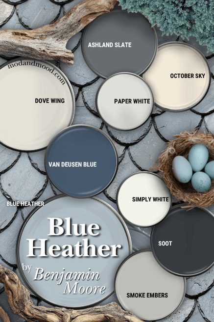 Color palette for Benjamin Moore Blue Heather features that color alongside Soot, Smoke Embers, Simply White, Dove Wing, Van Deusen Blue, October Sky, Paper White, and Ashland Slate, all on paint lids scattered over a gray shale background with driftwood and a robins egg nest