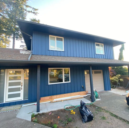 Benjamin Moore Newburyport Blue on a bilevel exterior.