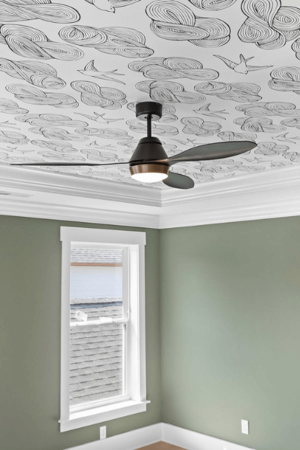 Sherwin Williams Dried Thyme on walls in a bright room with black and white wallpaper one the ceiling and a ceiling fan
