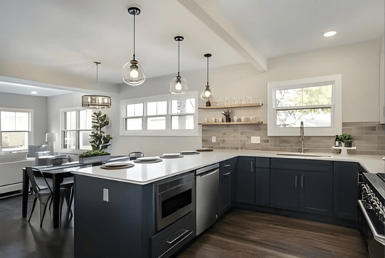 Benjamin Moore Gray Owl on kitchen walls with dark charcoal navy cabinets.