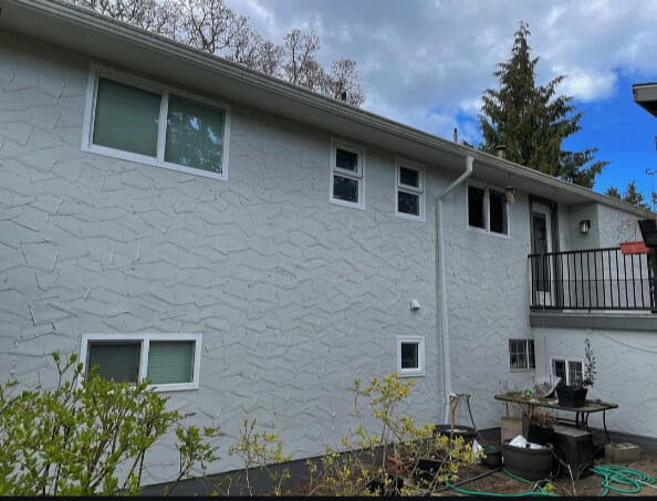 Benjamin Moore Gray Owl on a stucco Exterior with Amherst Gray Trim where it looks like a cool gray.