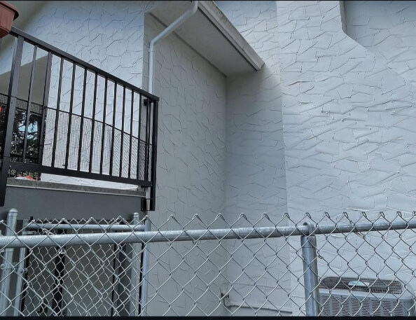 Benjamin Moore Gray Owl on a stucco Exterior with Amherst Gray Trim where it looks like a cool gray but almost white.