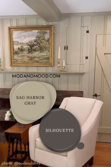 Paint dot swatch of Benjamin Moore Silhouette with the same of coordinating color Sag Harbor Gray over a background of Sag Harbor Gray on a panelled wall.