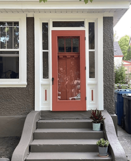 Benjamin Moore Silhouette on an exterior with an orange front door and white trim.