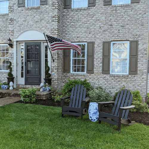 Benjamin Moore Silhouette on shutters of a brick two storey home.