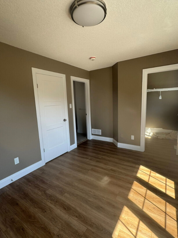 Benjamin Moore Weimaraner on walls with wood flooring and a large window, where the color looks more a little more earthy.