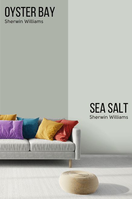 Oyster Bay on one half of a wall and Sea Salt on the other half behind a light gray sofa with jewel toned kitchens.